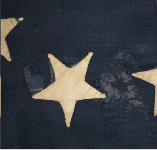 Light-colored star shapes appliquéd onto a dark blue textile ground.